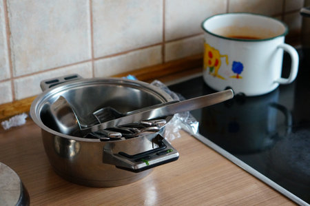 The aluminum pan with other kitchen utensils on the kitchen counterの写真素材