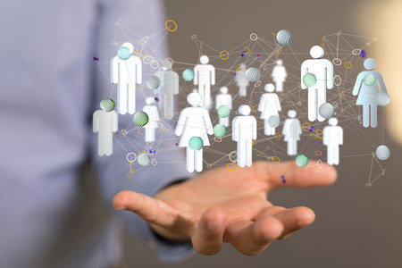 A 3D rendering of a group of floating people icons on a businessman's handの写真素材
