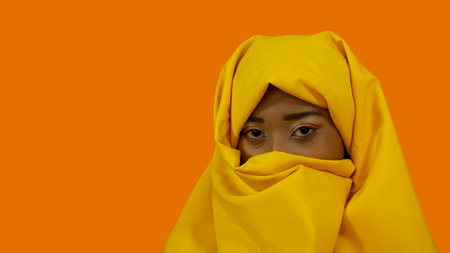 A portrait of an African American female in a bright yellow hijab.の写真素材