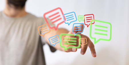 A 3D rendering of digital email icons with hand touching it from behind- online communication conceptの写真素材