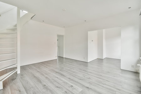 The interior of an empty room with white walls
