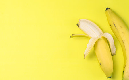 A top view of bananas isolated on the yellow backgroundの写真素材