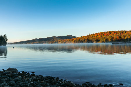 A scenic view of the Moosehead Lake at Baxter State Park during an early fall afternoonの写真素材