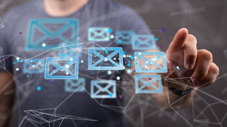 A 3D rendering of a man pointing at floating email icons - Concept of business communicationの写真素材