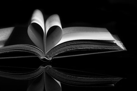 A closeup shot of book pages folded in the shape of a heartの写真素材