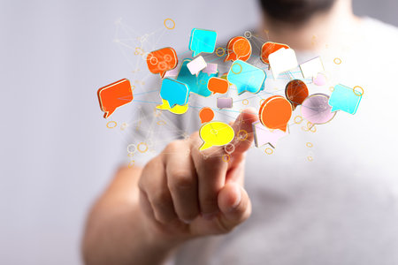 A 3D rendering of a businessman pointing at floating email icons against a dark blue backgroundの写真素材