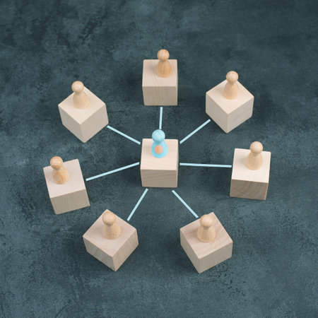 One person is standing in the middle of the circle and connects through lines to the other people of the groupの写真素材