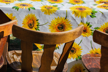 A closeup of the white tablecloth with a sunflower pattern.