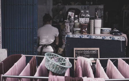 A closeup of laundry drying on a rack outdoors with a person doing housework in the backgroundの写真素材