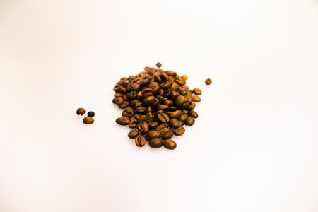 A closeup shot of coffee beans on a white backgroundの写真素材