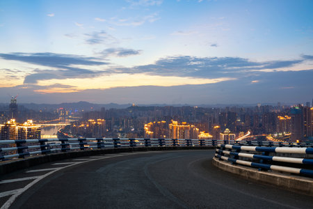 empty asphalt road with modern cityscape during sunset. copy space for car advertisement.の写真素材