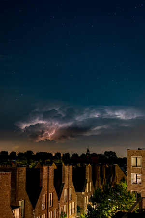The stormy clouds in a dark night sky over the town