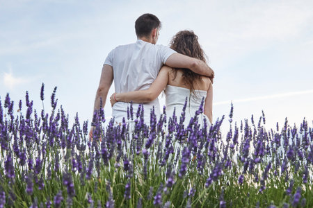 A beautiful young couple in the lavender field.の写真素材