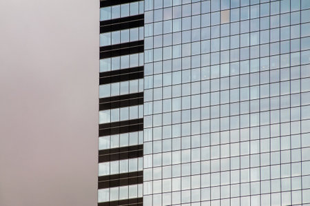 A closeup of the exterior of a a building with big glass windows