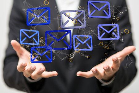 A 3D rendering of beige email icons with hand pointing at it from the background- digital business communication conceptの写真素材