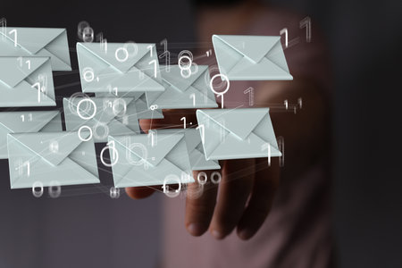 A 3D rendering of digital envelopes with hand touching it from behind- online communication conceptの写真素材