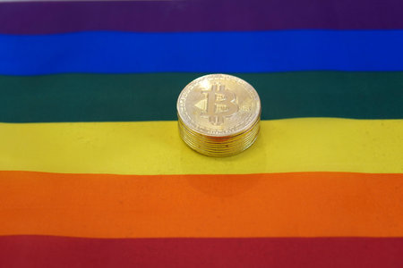 A closeup of bitcoins on an LGBT Pride flag