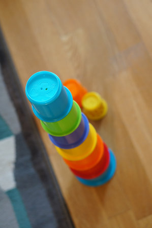 A vertical shot of the toy plastic pyramid cups on the floorの写真素材