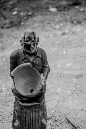 A selective of an old broken statue of a peasant manの写真素材