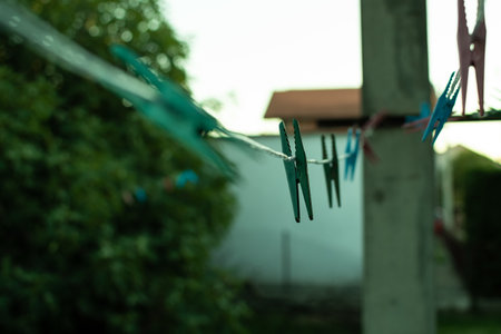 A shallow focus shot of an empty laundry rope with pegsの写真素材