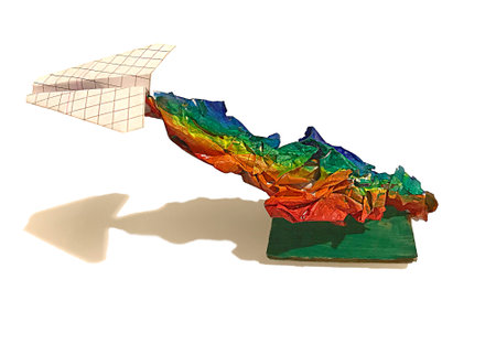 Handmade paper airplane with LGBT rainbow symbol isolated on the white background. Made of squared notebook paper. Dropping shadow below.の写真素材