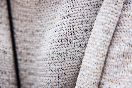 A closeup shot of a gray sweater
