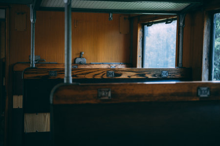 A closeup of numbered bus seats on a wooden surface in an old bus