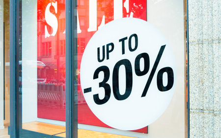 A big discount label in showcase of a store during sales season.