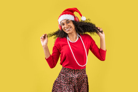 A young Hispanic female with a Santa hat excited for New Year's Eveの写真素材