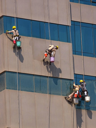 A vertical shot of cleaners washing up the buildingの写真素材