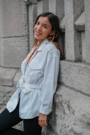 A vertical shot of a Caucasian (white) girl posing for the camera outside in United States