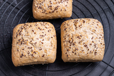 A closeup shot of small loaves of breads with sunflower, sesame and poppy seeds