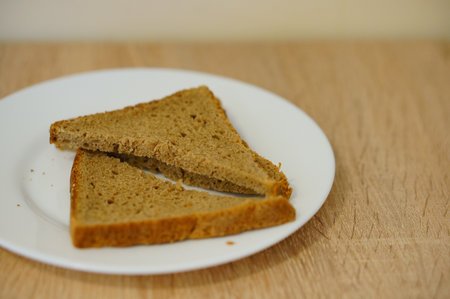 A plate with pieces of bread on the kitchen table
