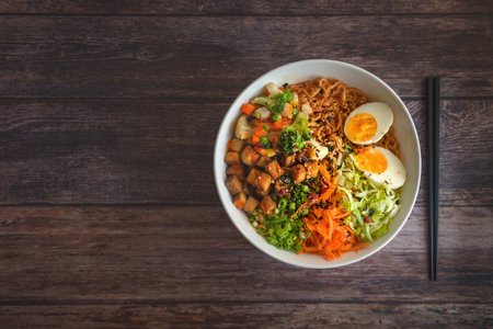 A top view of homemade ramen soup on a wooden table.の写真素材
