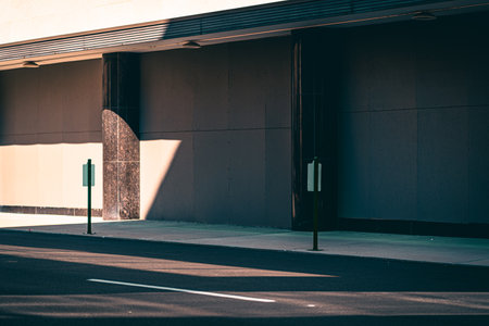 An empty street outside a building on a sunny dayの写真素材