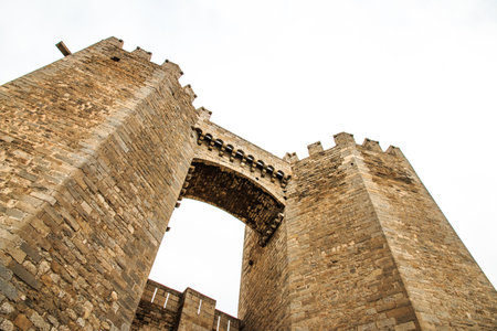 A low angle shot of Puerta de San Miguel in Morella, Spainの写真素材