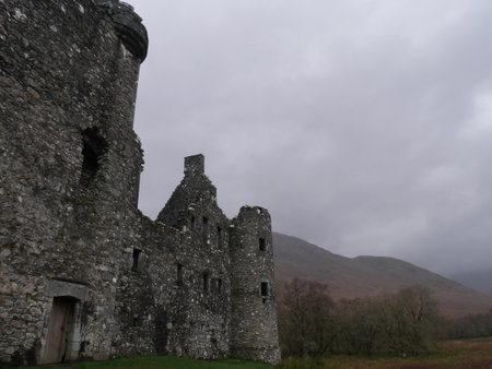 The ancient ruins of the Kilchurn Castle in a gloomy weatherの写真素材
