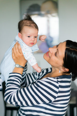 A close up of a mother hugging the cute baby daughter with loveの写真素材