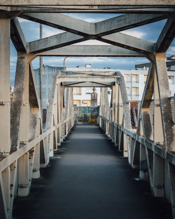 A footpath on the bridge with an abstract structure