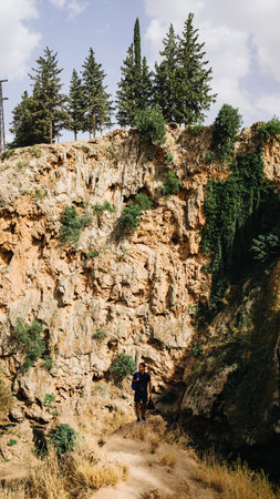 A vertical shot of a guy hiking in the mountainsの写真素材