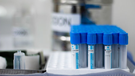 A selective focus of test tubes put to analysis with the lab in the background