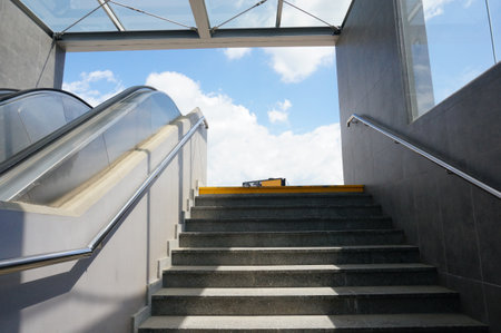 A low angle shot of stairs with handrails leading up from the underground passageの写真素材