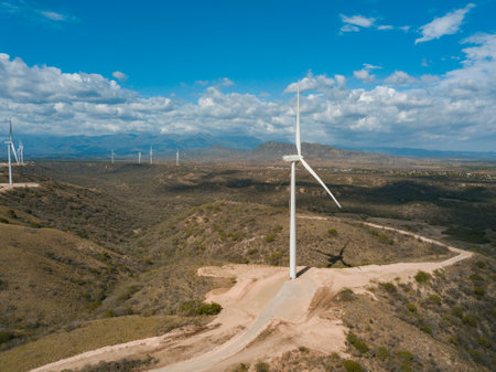 A landscape of the Wind Park Matafongo under a blue cloudy sky in Bani, the Dominican Republicの写真素材