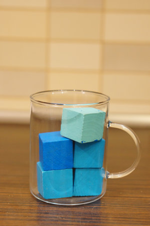 Blue-colored bathing cubes in a glass cupの写真素材