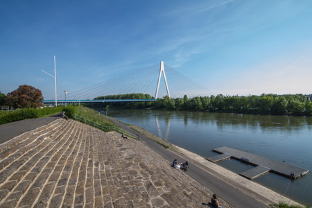 The dyke of the river Rhine in Neuwied, Germany, in the sun with the bridge in backgroundの写真素材