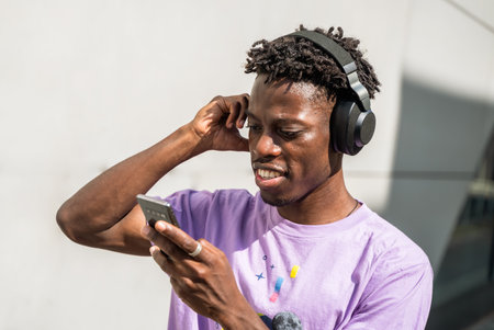 A black male model wearing headphones and enjoying music in Berlin, Germanyの写真素材