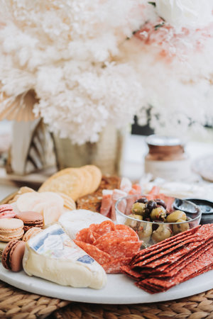 A vertical shot of fruit and cheese platter on a tableの写真素材