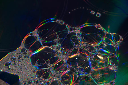 A closeup shot of a pile of soap bubbles on a holographic backgroundの写真素材