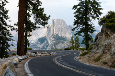 A landscape of the Glacier Point Road surrounded by rocky hills in Yosemite National Park, Californiaの写真素材