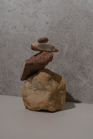 A vertical shot of a stone stack on a stone background